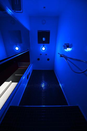a bathroom with blue lights and a black floor at CHIC HOUSE MATERA - Design e Parking a 200m dai Sassi in Matera
