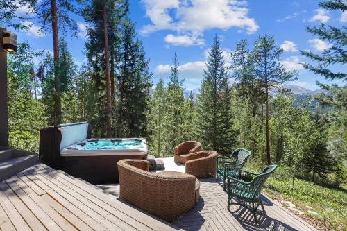 a deck with a hot tub and chairs on it at Bear Peak Lodge 1 Mile to Gondola and Great Views in Breckenridge