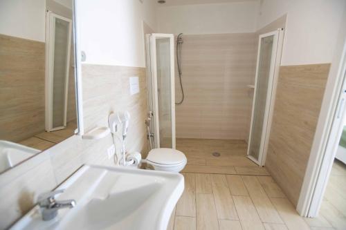 a bathroom with a toilet and a sink and a shower at Hotel Sole in Lampedusa