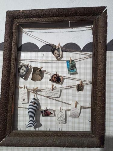 a picture of a group of people hanging on a wall at La casa dei nonni in Bracelli