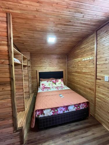 a small room with a bed in a wooden cabin at Campo Eden in Capitán Miranda
