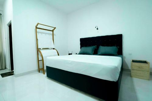 a bedroom with a large bed and a mirror at Prime Inn Kandy in Kandy