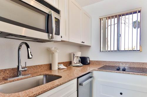 a kitchen with a sink and a microwave at The Surf Club Resort in Montauk