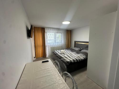 a small room with a bed and a table at Nord Accomodation in Bucharest