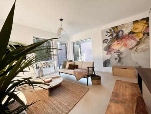 a living room with a couch and a chair at Les Villas de l'Ill in Didenheim