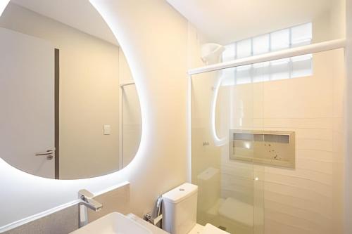 a bathroom with a sink and a mirror at Sea View + Pool | Cliffs Mar 209 in Pipa