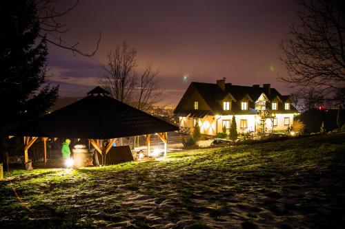 a house with a gazebo at night at Mileżówka - Noclegi&SPA in Ustroń