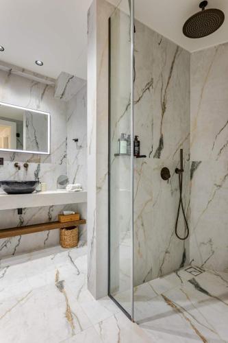 a bathroom with a shower and a sink at RIRIKA Beach Living, New Seaside Apartments in Plakias in Plakias