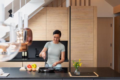 a man standing in a kitchen preparing food at dasHuber-Hochrindl in Hochrindl