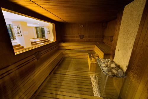 an empty sauna with a bench and a window at Qafqaz Baku City Hotel & Residences in Baku
