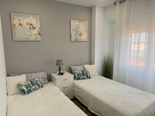 a bedroom with two beds and a window at Apartamento Mart in Miami Platja