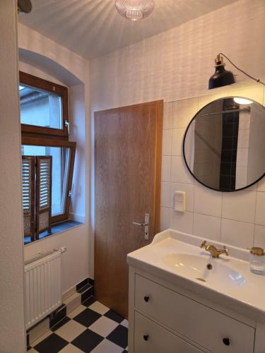 a bathroom with a sink and a mirror at Apartment 2 im Martinsgarten Angermünde in Angermünde