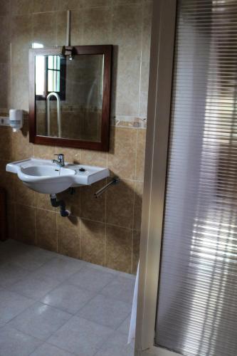 a bathroom with a sink and a mirror at Hostal Rural La Plata Parking Incluido in Arcos de la Frontera
