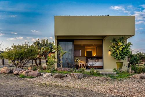 a small house in the middle of a field at Villa Lua, 2BR Countryside Bungalows for 6 Guests in La Talega
