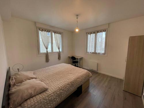 a bedroom with a bed and two windows at LEvasion de Brest - Près du Tram - 5 Voyageurs in Brest