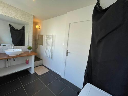 a bathroom with a white sink and a shower at LEvasion de Brest - Près du Tram - 5 Voyageurs in Brest