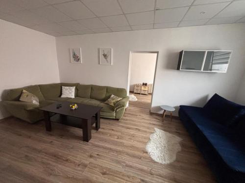 a living room with a couch and a table at Cozy place in Stará Ľubovňa