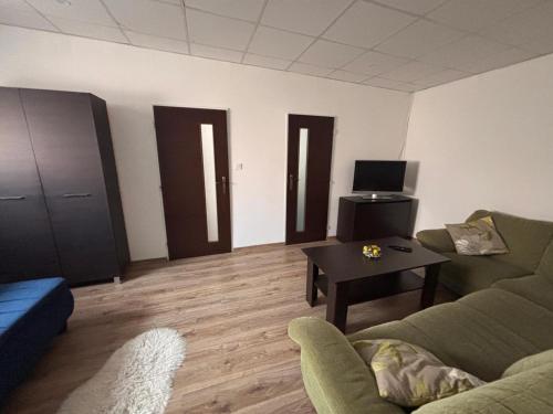 a living room with a couch and a table at Cozy place in Stará Ľubovňa