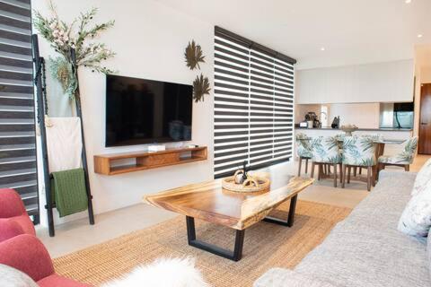 a living room with a couch and a coffee table at Casa CooLas in Cozumel