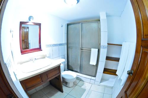a bathroom with a sink and a shower and a toilet at Hotel Europeo in Managua