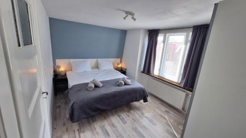 a bedroom with a bed with two teddy bears on it at Upstairs Stay Alkmaar in Alkmaar