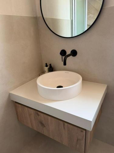 a bathroom with a white sink and a mirror at Vue de Valleé in Wellington