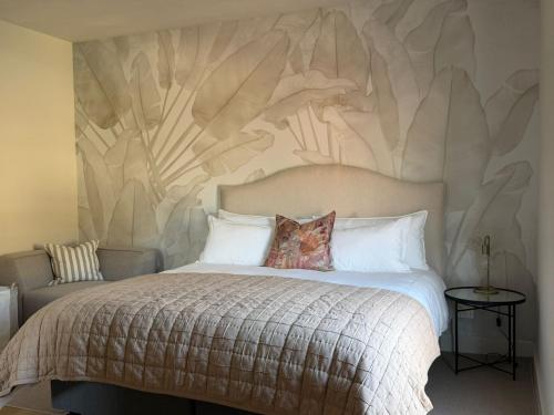 a bedroom with a bed with a wall mural at Vue de Valleé in Wellington