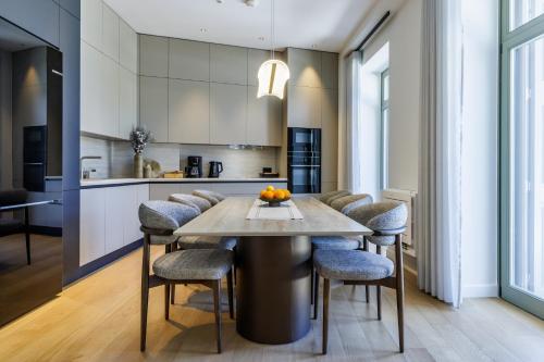 a kitchen with a table with chairs and a kitchen with white cabinets at Cavo Mare Skopelos in Skopelos Town