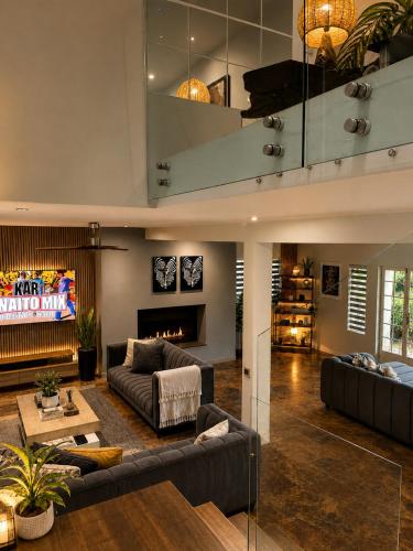 a living room with two couches and a fireplace at Ekhaya in Hartbeespoort