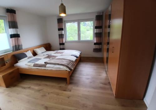 a bedroom with a bed and a window at Ferienwohnung Buchenblatt in Simmerath