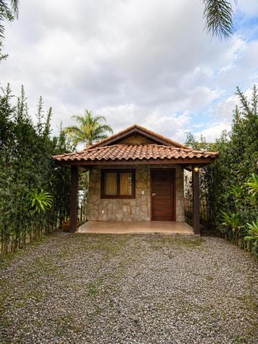 a small home with a stone house at Refúgios de Mauá - Chalé Serra in Visconde De Maua