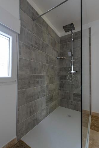 a shower with a glass door in a bathroom at Ô Bois Jer'Home in Bois-Jérôme-Saint-Ouen