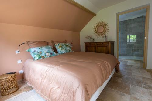 a bedroom with a large bed and a mirror at Ô Bois Jer'Home in Bois-Jérôme-Saint-Ouen