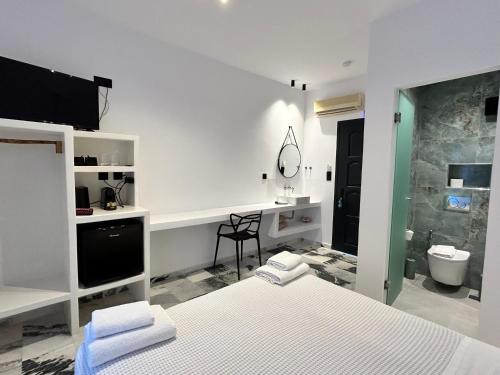 a bedroom with two beds and a bathroom with a sink at Delight Apartments suites in Stelida