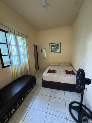 a bedroom with a bed and a large window at Recanto Mozão in Angra dos Reis