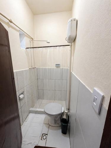 a small bathroom with a toilet and a shower at Recanto Mozão in Angra dos Reis