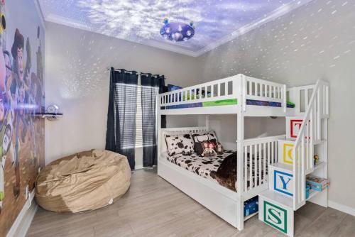 a childs bedroom with a white bunk bed at Andy's Hideaway at Bahama Bay - Sage Vacations in Kissimmee