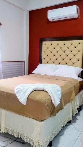 a bedroom with a large bed with a large headboard at Hotel Urban Center RM in San Marcos