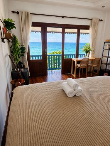 a bedroom with a bed with two towels on it at Nami by Secret Place in Mae Haad