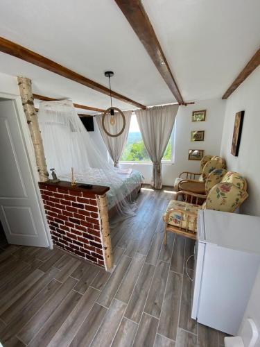 a bedroom with a bed and a brick fireplace at Casutele Verzi Camera King in Ocnele Mari