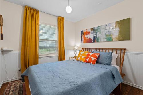 a bedroom with a blue bed and a window at Bright 3BR | 25 mins to Arrowhead | Groups & Pets in Mission