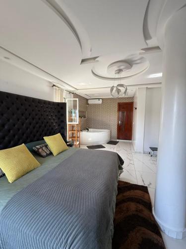 a bedroom with a large bed and a bath tub at Blue ocean villa in Asilah
