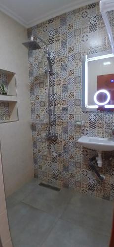 a bathroom with a shower and a sink at Blue ocean villa in Asilah