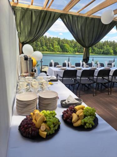 a table with plates of grapes and plates of food at Krokodyl Sport&Spa in Mielno