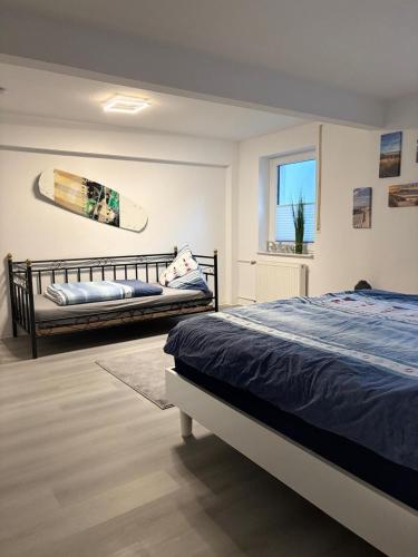 a bedroom with a bed and a surfboard on the wall at Finca Bornrows Nähe Bad Oeynhausen in Vlotho