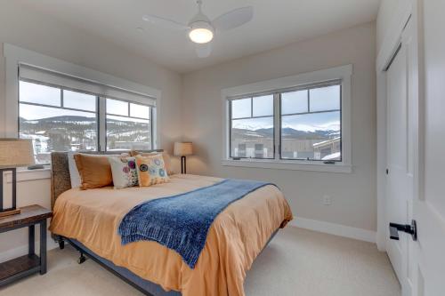 a bedroom with a bed and two windows at Downtown WP Corner Loft 24 I Hot Tub I Great Views I Bunk Beds I Activity Program in Winter Park