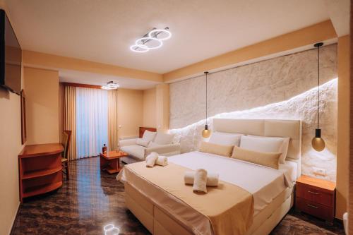 a hotel room with a large bed and a couch at Villa Dislievski in Ohrid