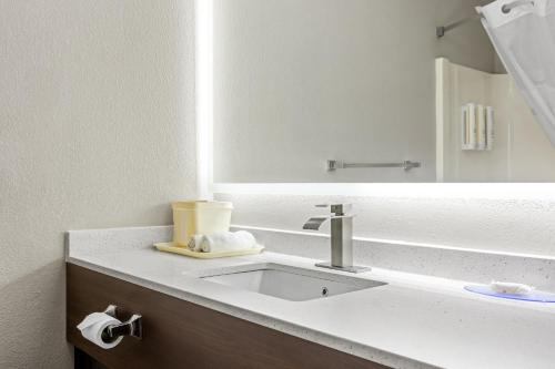 a bathroom with a sink and a mirror at Clarion Pointe Jesup in Jesup