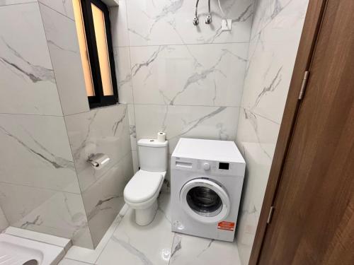 a bathroom with a toilet and a washing machine at Brand new Oceanview Penthouse by MaBeLi in St. Paul's Bay