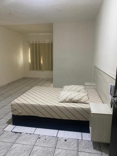 a bedroom with a large bed in a room at Hospedaria São Mateus in São Paulo